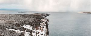 Preview wallpaper island, coast, aerial view, snow, buildings