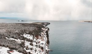 Preview wallpaper island, coast, aerial view, snow, buildings