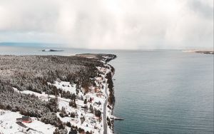 Preview wallpaper island, coast, aerial view, snow, buildings