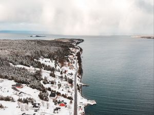 Preview wallpaper island, coast, aerial view, snow, buildings