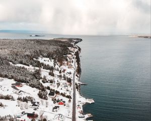 Preview wallpaper island, coast, aerial view, snow, buildings