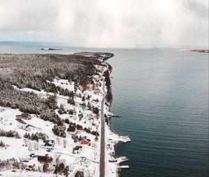 Preview wallpaper island, coast, aerial view, snow, buildings