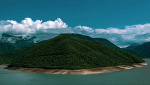 Preview wallpaper island, coast, hills, clouds, forest, vegetation
