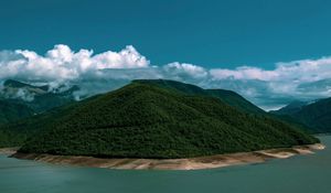 Preview wallpaper island, coast, hills, clouds, forest, vegetation