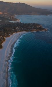Preview wallpaper island, coast, sea, city, evening