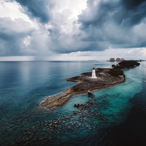 Preview wallpaper island, lighthouse, sea, clouds, landscape