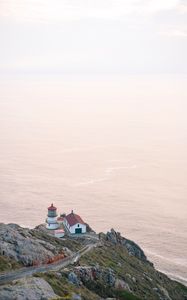 Preview wallpaper island, rock, ocean, lighthouse, twilight