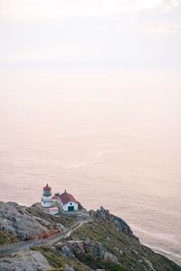 Preview wallpaper island, rock, ocean, lighthouse, twilight