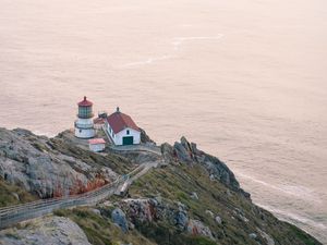 Preview wallpaper island, rock, ocean, lighthouse, twilight