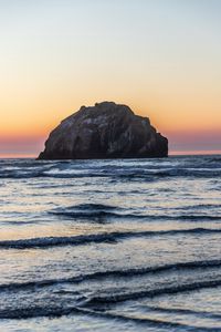 Preview wallpaper island, rock, sea, waves, dusk, landscape