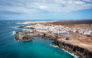 Preview wallpaper island, sea, buildings, aerial view