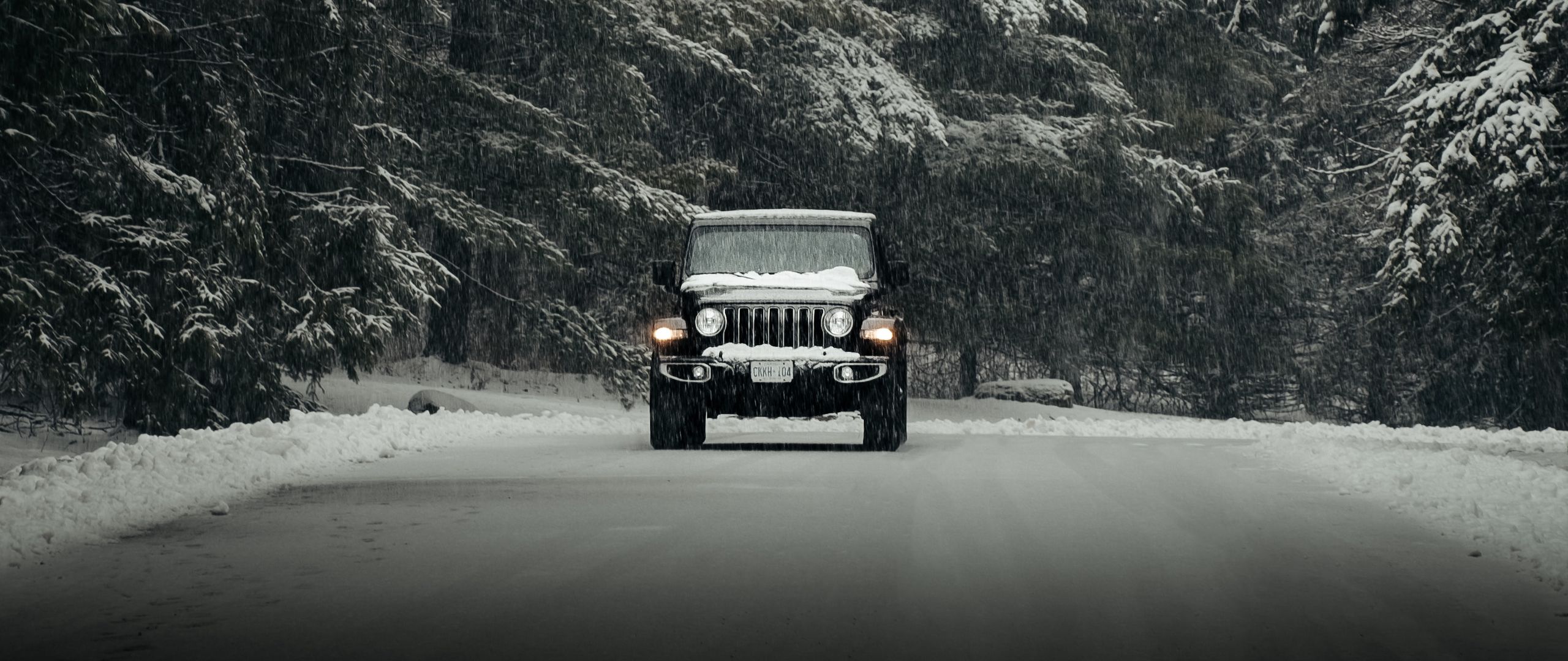 Download wallpaper 2560x1080 jeep wrangler, jeep, car, suv, black, snow,  road dual wide 1080p hd background