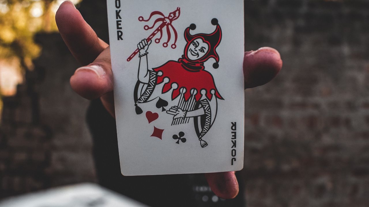 Wallpaper joker, card, fingers, hand