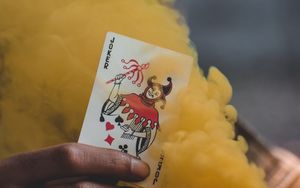 Preview wallpaper joker, playing card, smoke, yellow, hand