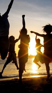 Preview wallpaper jump, people, happiness, light, sunset