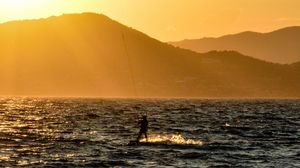 Preview wallpaper kitesurfing, man, sunset, sea, glare