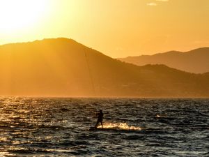 Preview wallpaper kitesurfing, man, sunset, sea, glare