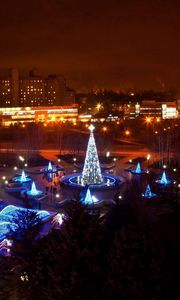 Preview wallpaper krivoy rog, night city, new year, beauty, turquoise, blue, houses, streets, trees, tree, fountain