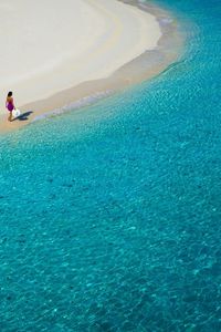Preview wallpaper lagoon, blue water, beach, coast, girl, hat, sand, resort, rest