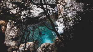 Preview wallpaper lake, branches, stones, water