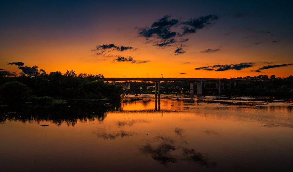 1024x600 Wallpaper lake, bridge, trees, clouds, sky, sunset, dark
