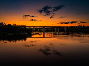 Preview wallpaper lake, bridge, trees, clouds, sky, sunset, dark