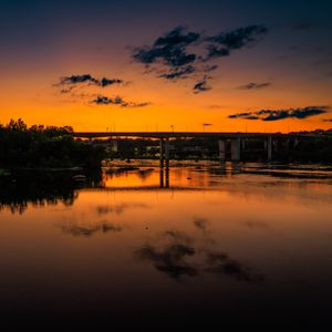 Preview wallpaper lake, bridge, trees, clouds, sky, sunset, dark