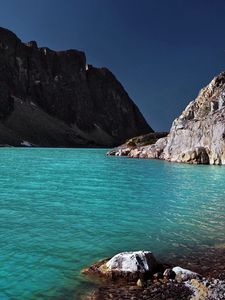 Preview wallpaper lake, coast, azure, stones, pebble, mountains