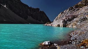 Preview wallpaper lake, coast, azure, stones, pebble, mountains