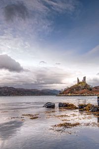 Preview wallpaper lake, coast, stones, sharp, cloudy