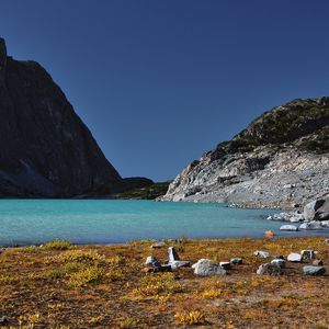 Preview wallpaper lake, coast, stones, azure, sky, moon, grass, faded