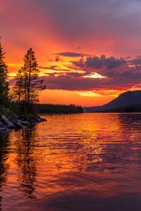 Preview wallpaper lake, coast, sunset, ripples, reflection, landscape