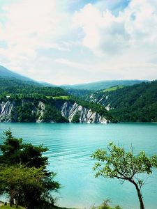 Preview wallpaper lake, coast, trees, bushes, azure, surface, clouds, sky, landscape