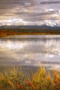 Preview wallpaper lake, grass, cloudy, bad weather, despondency, mountains