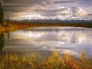 Preview wallpaper lake, grass, cloudy, bad weather, despondency, mountains