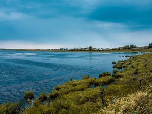 Preview wallpaper lake, grass, shore, horizon, clouds, sky