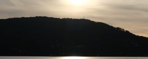 Preview wallpaper lake, hill, silhouette, sun, evening