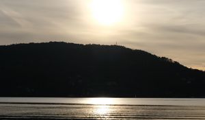 Preview wallpaper lake, hill, silhouette, sun, evening