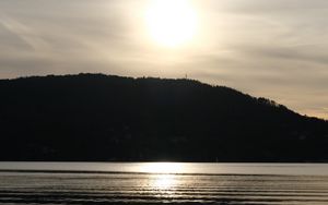 Preview wallpaper lake, hill, silhouette, sun, evening