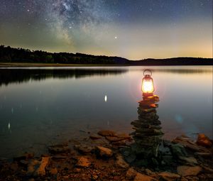 Preview wallpaper lake, lantern, night, shore, stones