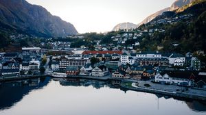Preview wallpaper lake, mountains, buildings, city, aerial view