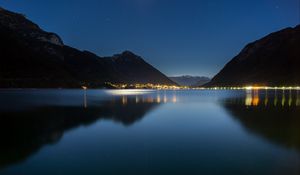 Preview wallpaper lake, mountains, city, lights, night, reflection