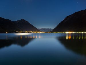 Preview wallpaper lake, mountains, city, lights, night, reflection