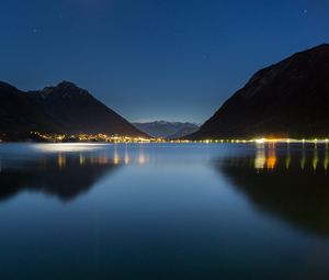 Preview wallpaper lake, mountains, city, lights, night, reflection