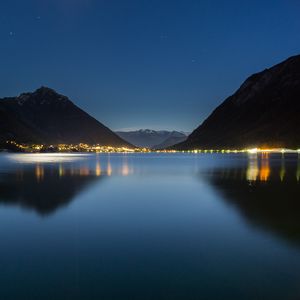 Preview wallpaper lake, mountains, city, lights, night, reflection
