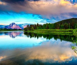 Preview wallpaper lake, mountains, clouds, smooth surface, reflection, sky, brightly, branches