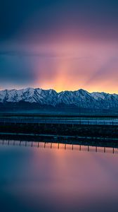 Preview wallpaper lake, mountains, road, dusk, sunset