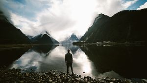 Preview wallpaper lake, mountains, rocks, man, loneliness