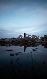 Preview wallpaper lake, mountains, silhouette, stones, shore