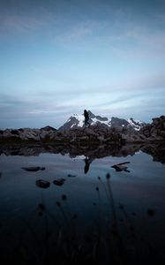 Preview wallpaper lake, mountains, silhouette, stones, shore